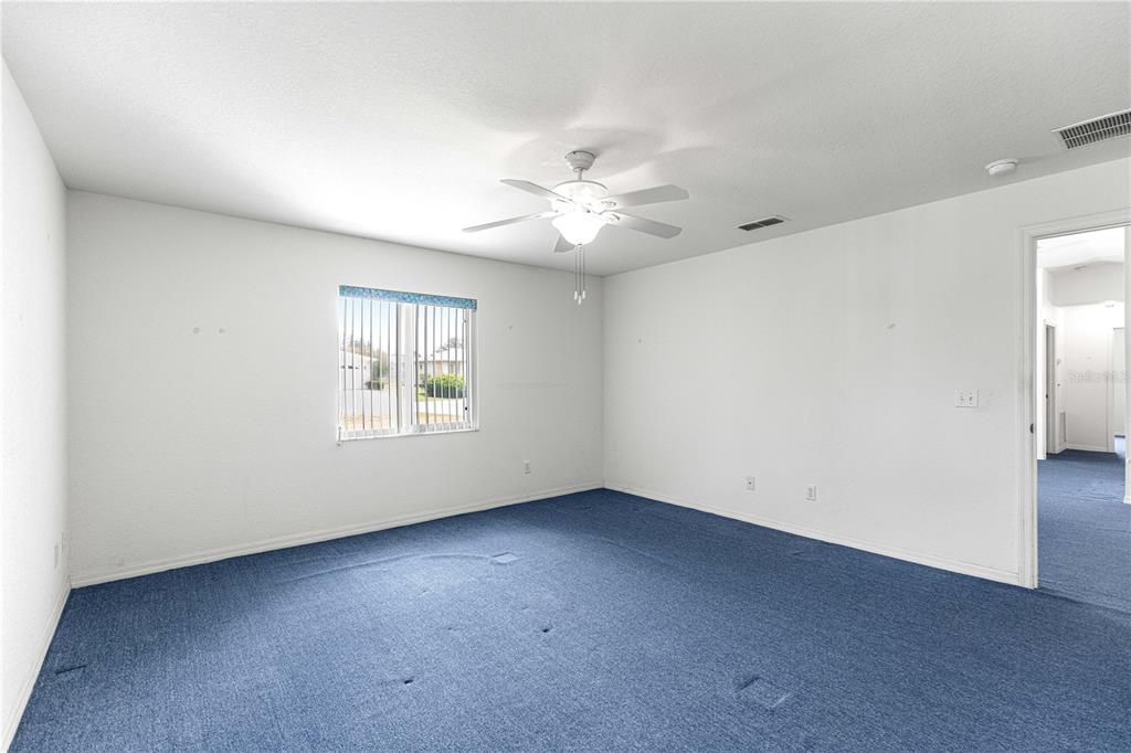 9840 Southwest 63rd Court Ocala, FL 34476 - Photo 12 of 49 an empty room with windows and fan