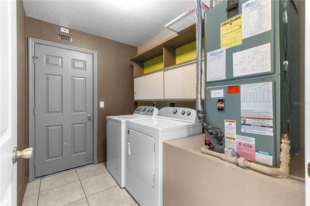 9840 Southwest 63rd Court Ocala, FL 34476 - Photo 13 of 49 a utility room with dryer and washer