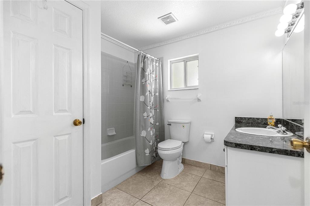 9840 Southwest 63rd Court Ocala, FL 34476 - Photo 14 of 49 a bathroom with a sink toilet and shower