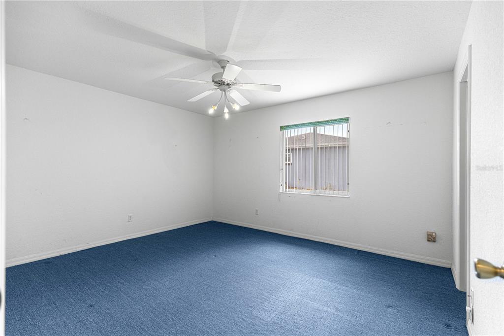 9840 Southwest 63rd Court Ocala, FL 34476 - Photo 16 of 49 an empty room with windows and fan