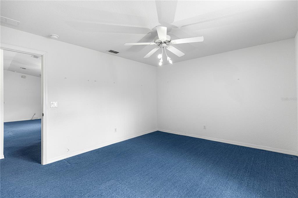 9840 Southwest 63rd Court Ocala, FL 34476 - Photo 17 of 49 an empty room with a fan & a window