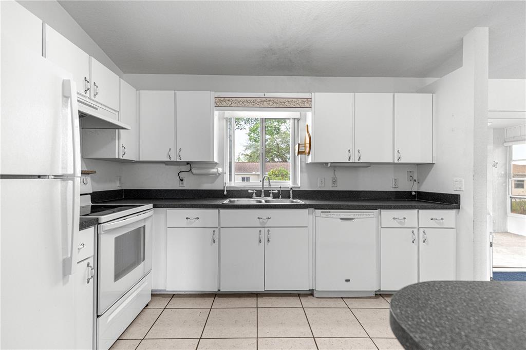 9840 Southwest 63rd Court Ocala, FL 34476 - Photo 22 of 49 a kitchen with white cabinets appliances and a window