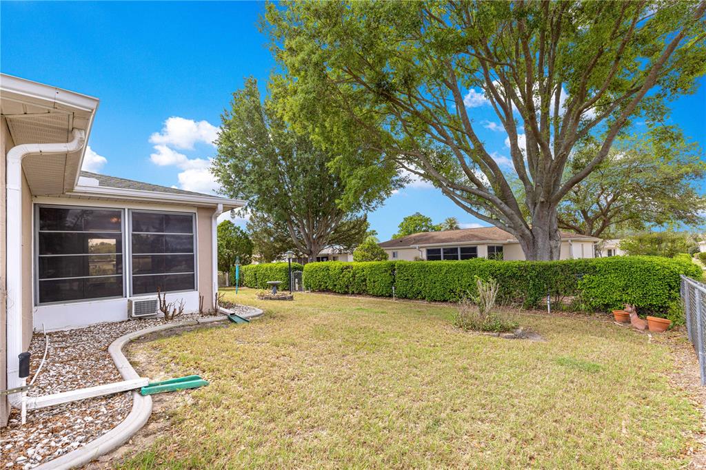9840 Southwest 63rd Court Ocala, FL 34476 - Photo 36 of 49 a view of a house with a yard and potted plants
