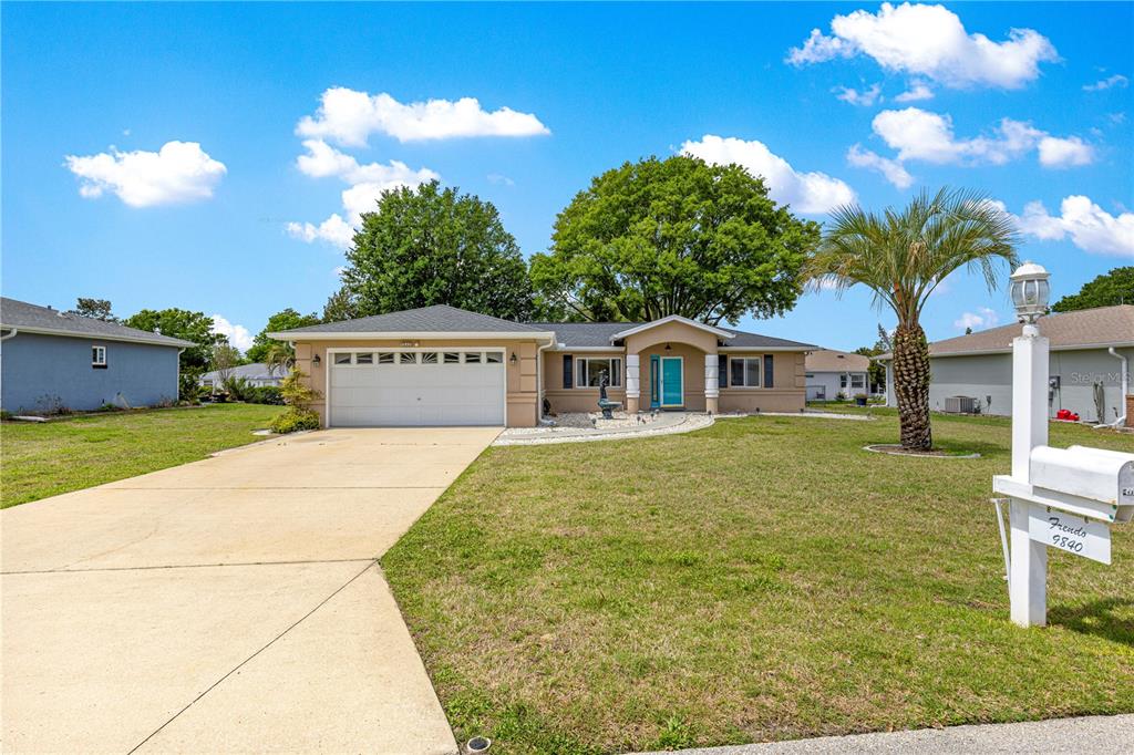 9840 Southwest 63rd Court Ocala, FL 34476 - Photo 39 of 49 a view of a house with a yard and garage