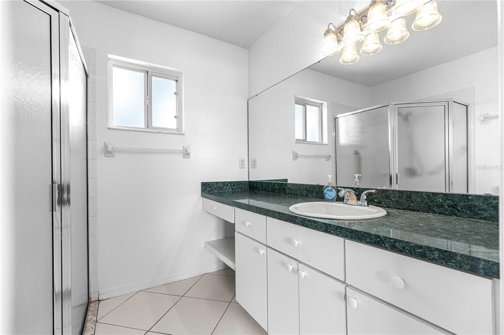 9840 Southwest 63rd Court Ocala, FL 34476 - Photo 10 of 49 a bathroom with a granite countertop double vanity sink and a mirror