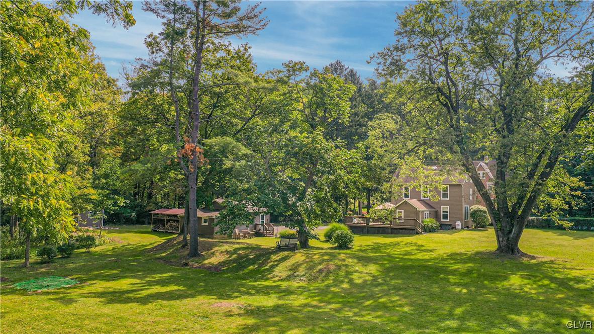 281 Old Furnace Road Riegelsville, PA 18077 - Photo 26 of 29 a view of a swimming pool with lawn chairs under an umbrella