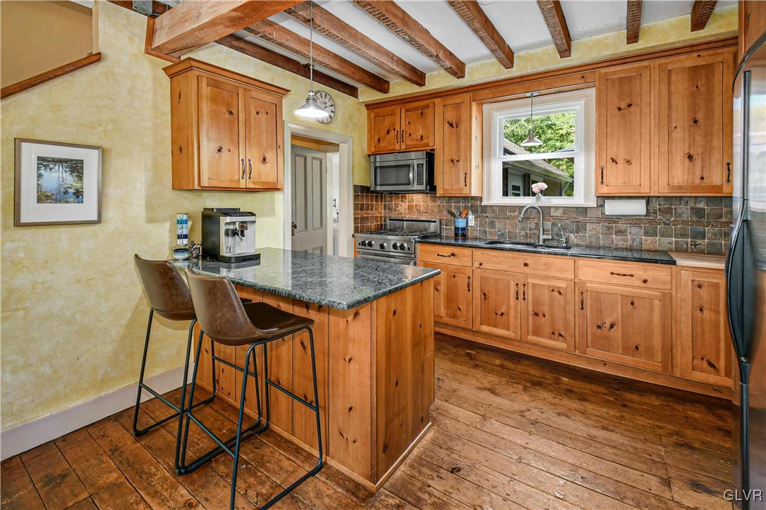 281 Old Furnace Road Riegelsville, PA 18077 - Photo 8 of 29 a kitchen with stainless steel appliances granite countertop a stove a sink dishwasher and cabinets with wooden floor