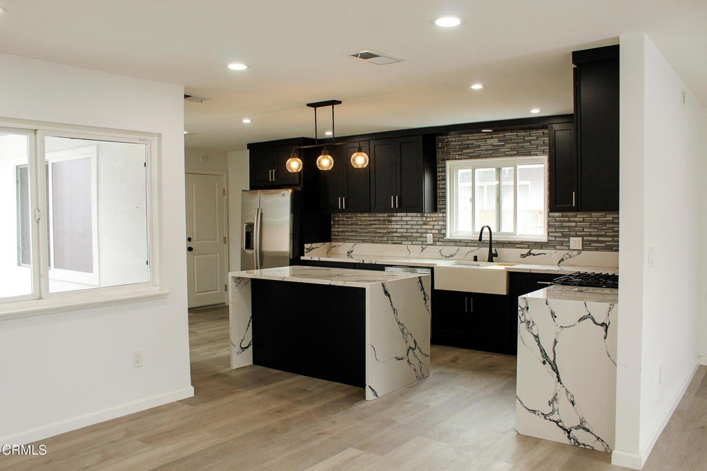 1430 Huntswood Way Oxnard, CA 93030 - Photo 2 of 14 a kitchen with a sink cabinets and window