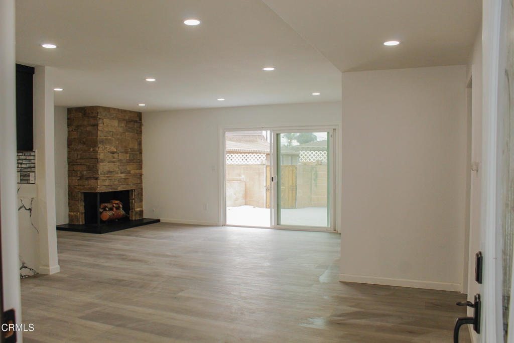 1430 Huntswood Way Oxnard, CA 93030 - Photo 3 of 14 a view of an empty room with a fireplace and a window