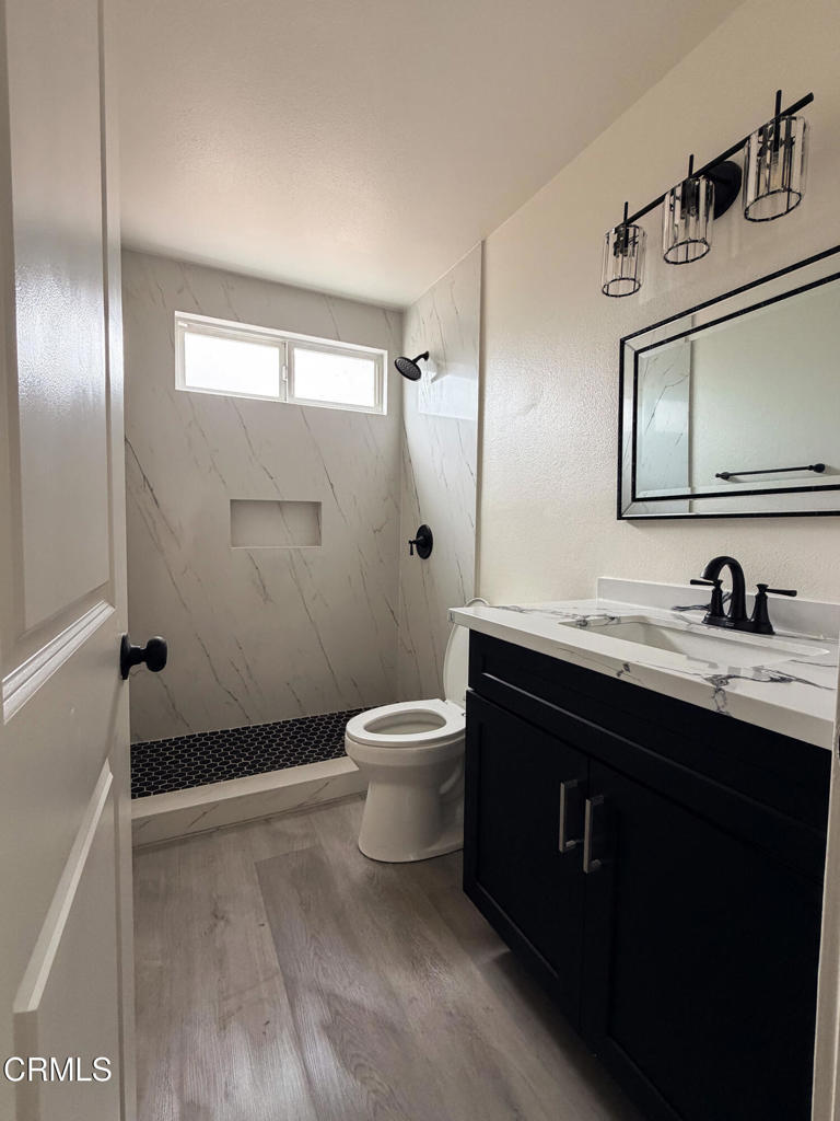1430 Huntswood Way Oxnard, CA 93030 - Photo 8 of 14 a bathroom with a granite countertop sink toilet a mirror and shower