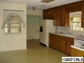 140 Nottingham Road Salisbury, NC 28147 - Photo 5 of 8 a kitchen with a refrigerator a sink and cabinets