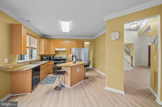 a kitchen with a sink appliances cabinets and a counter top space