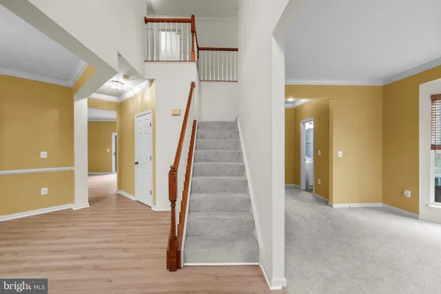 a view of a hallway view with wooden floor and staircase