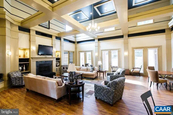 a living room with fireplace furniture and a flat screen tv