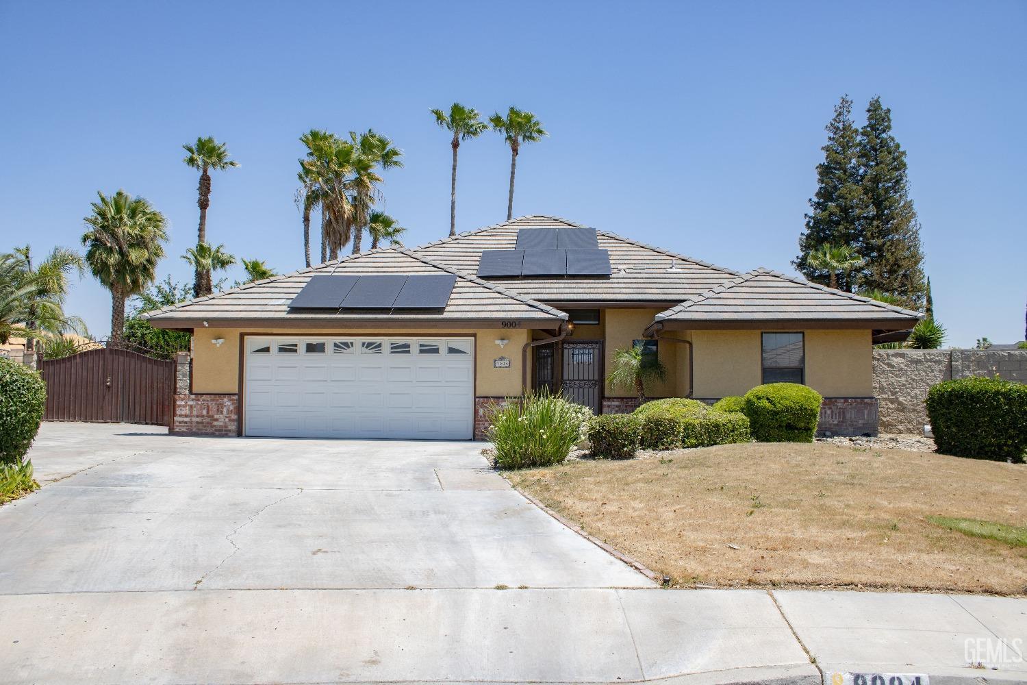 a front view of a house with a yard and potted plants