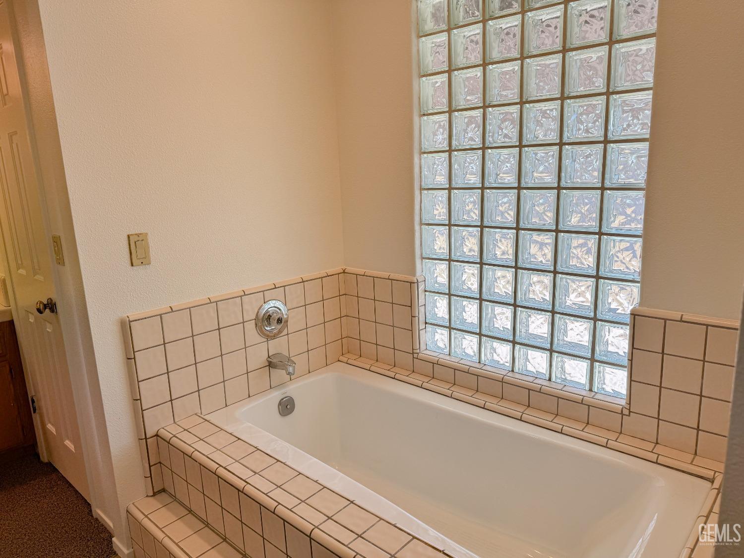 Undisclosed Address Bakersfield, CA 93307 - Photo 24 of 46 a bathroom with a bathtub and window