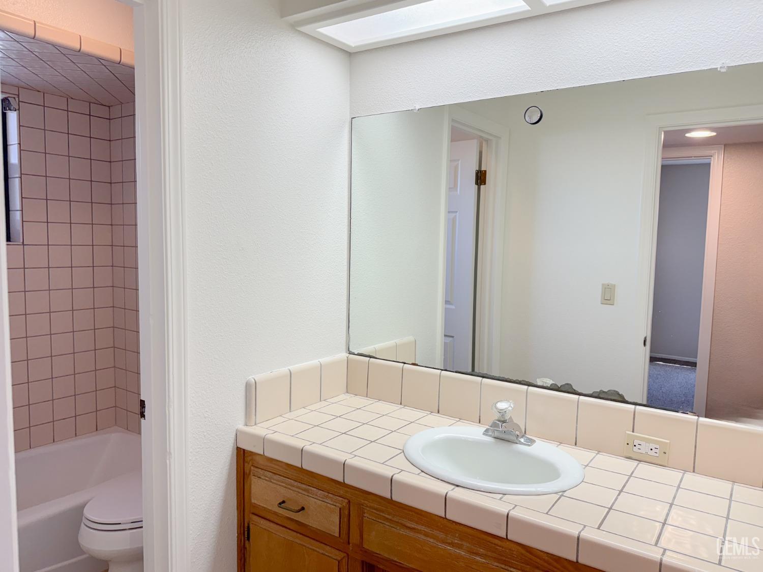 Undisclosed Address Bakersfield, CA 93307 - Photo 29 of 46 a bathroom with a granite countertop sink toilet and shower