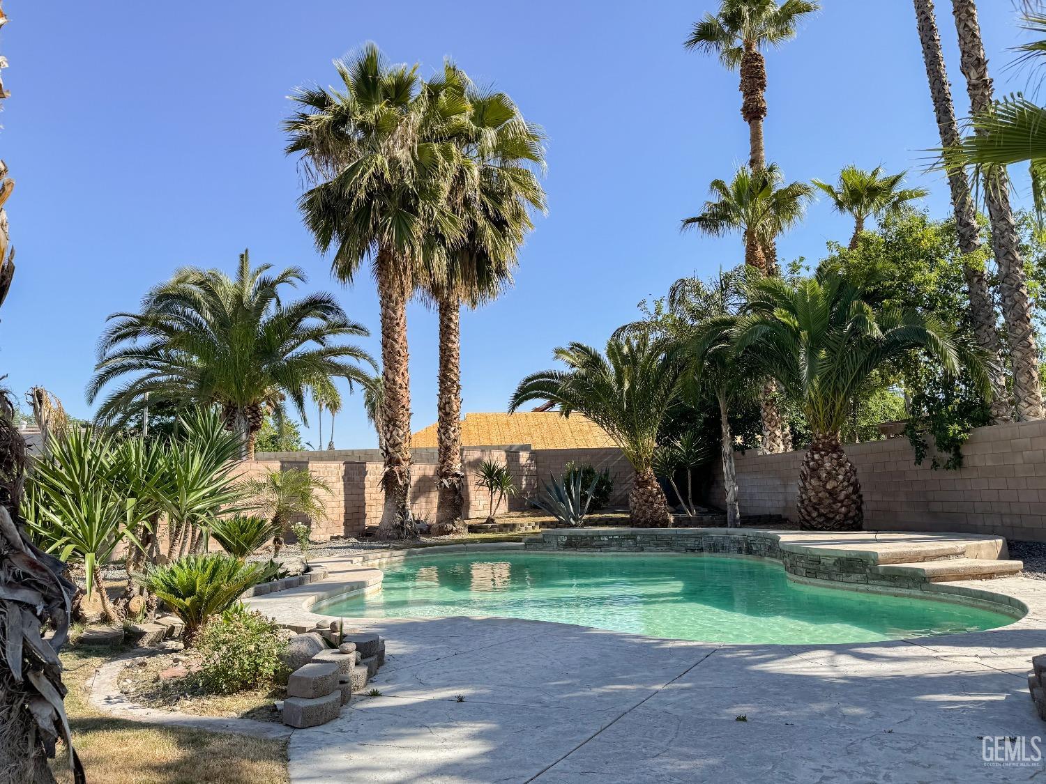Undisclosed Address Bakersfield, CA 93307 - Photo 32 of 46 a palm tree sitting in front of a house with a big yard