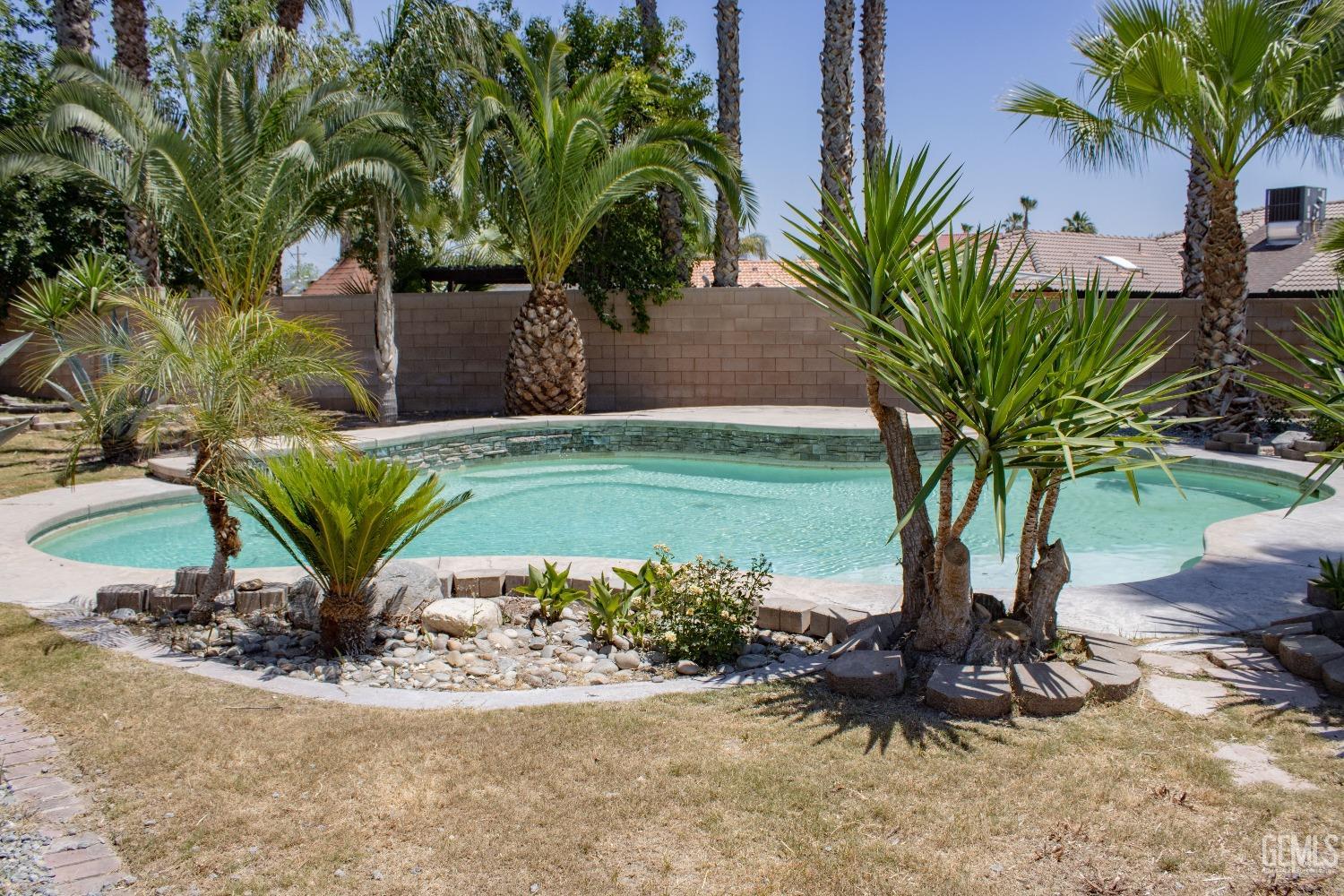Undisclosed Address Bakersfield, CA 93307 - Photo 34 of 46 a view of a backyard with a table and a chair