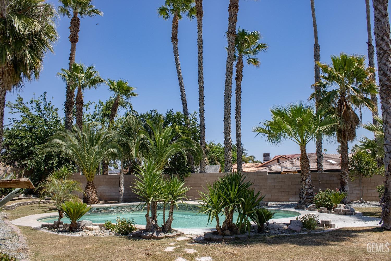 Undisclosed Address Bakersfield, CA 93307 - Photo 38 of 46 a couple of palm trees in front of a house