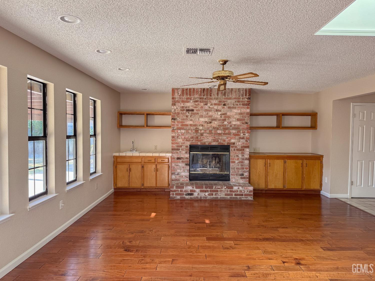 Undisclosed Address Bakersfield, CA 93307 - Photo 8 of 46 a living room with furniture and a fireplace