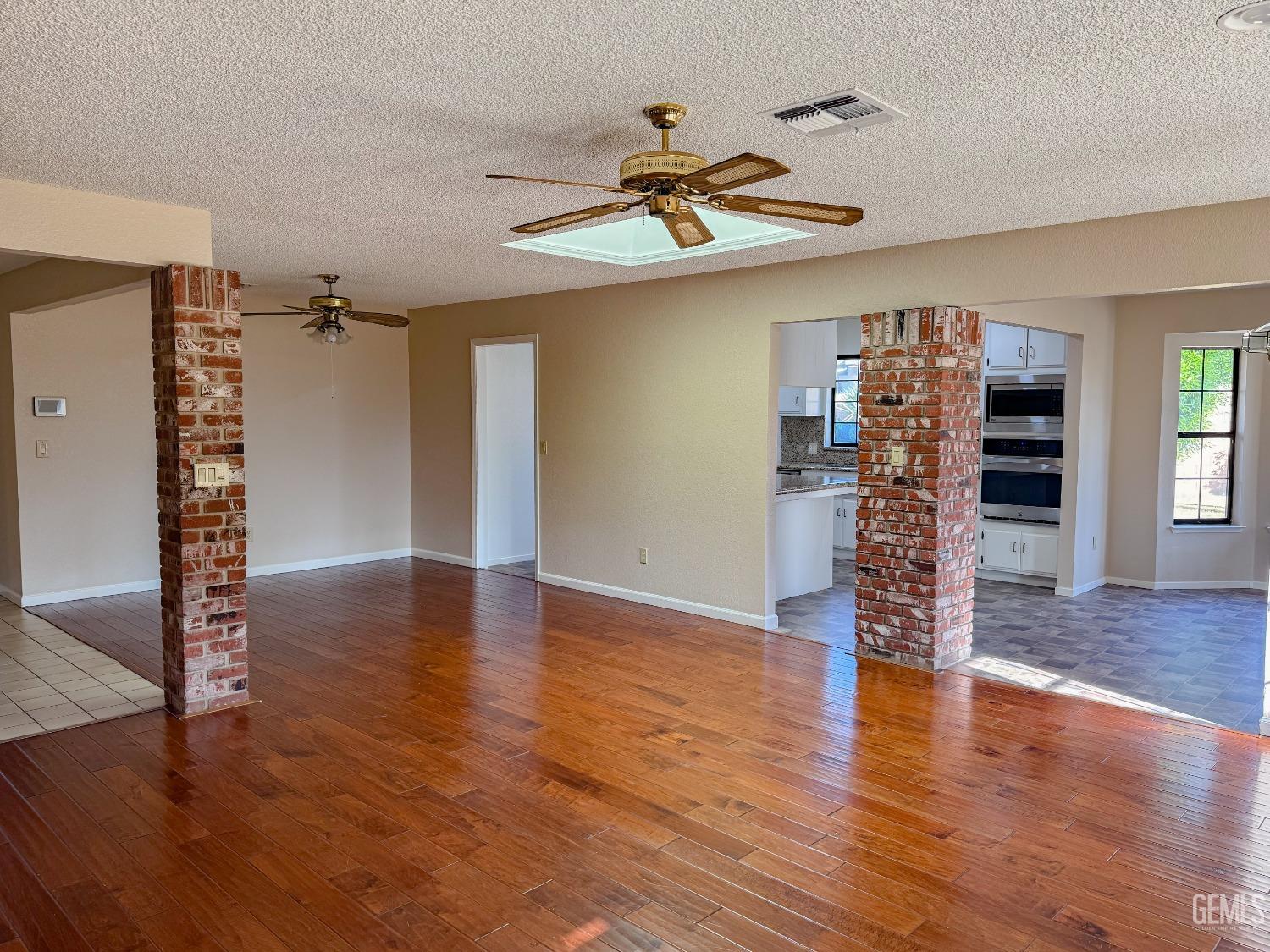 Undisclosed Address Bakersfield, CA 93307 - Photo 10 of 46 a view of empty room with wooden floor and fan