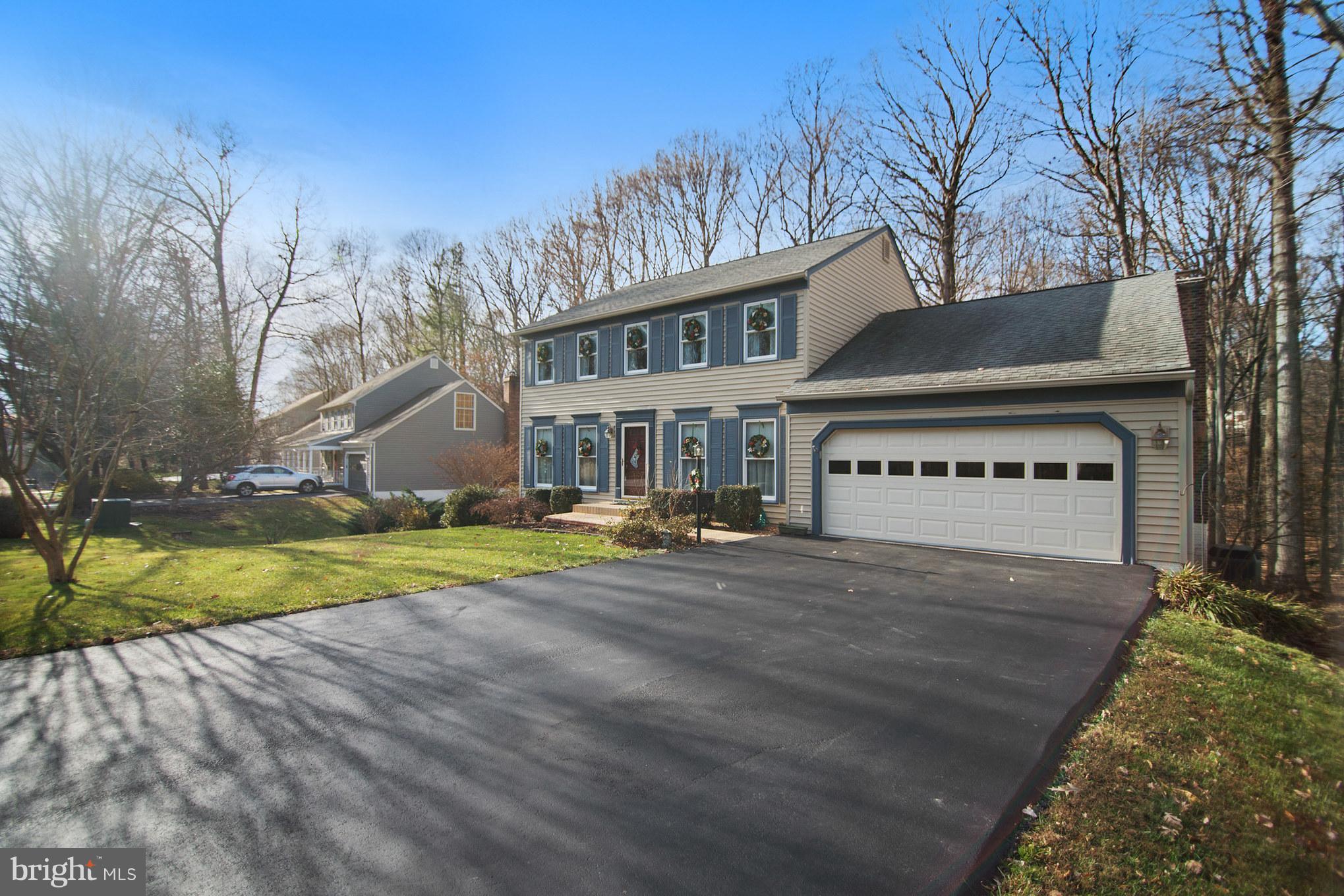 13016 Smoketown Road Woodbridge, VA 22192 - Photo 2 of 30 a view of a house with a big yard and large trees