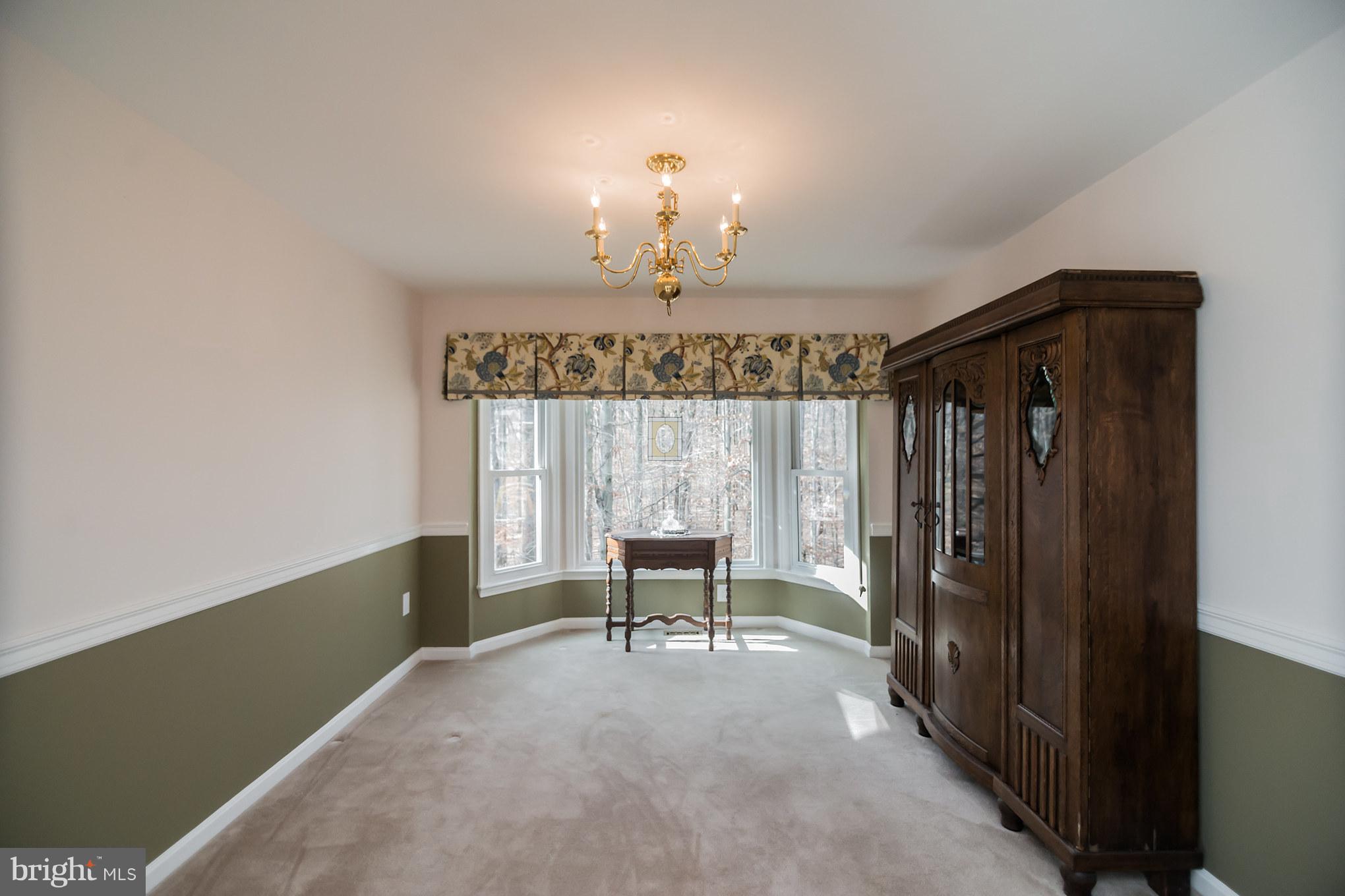 13016 Smoketown Road Woodbridge, VA 22192 - Photo 15 of 30 a view of a room with a chandelier and windows