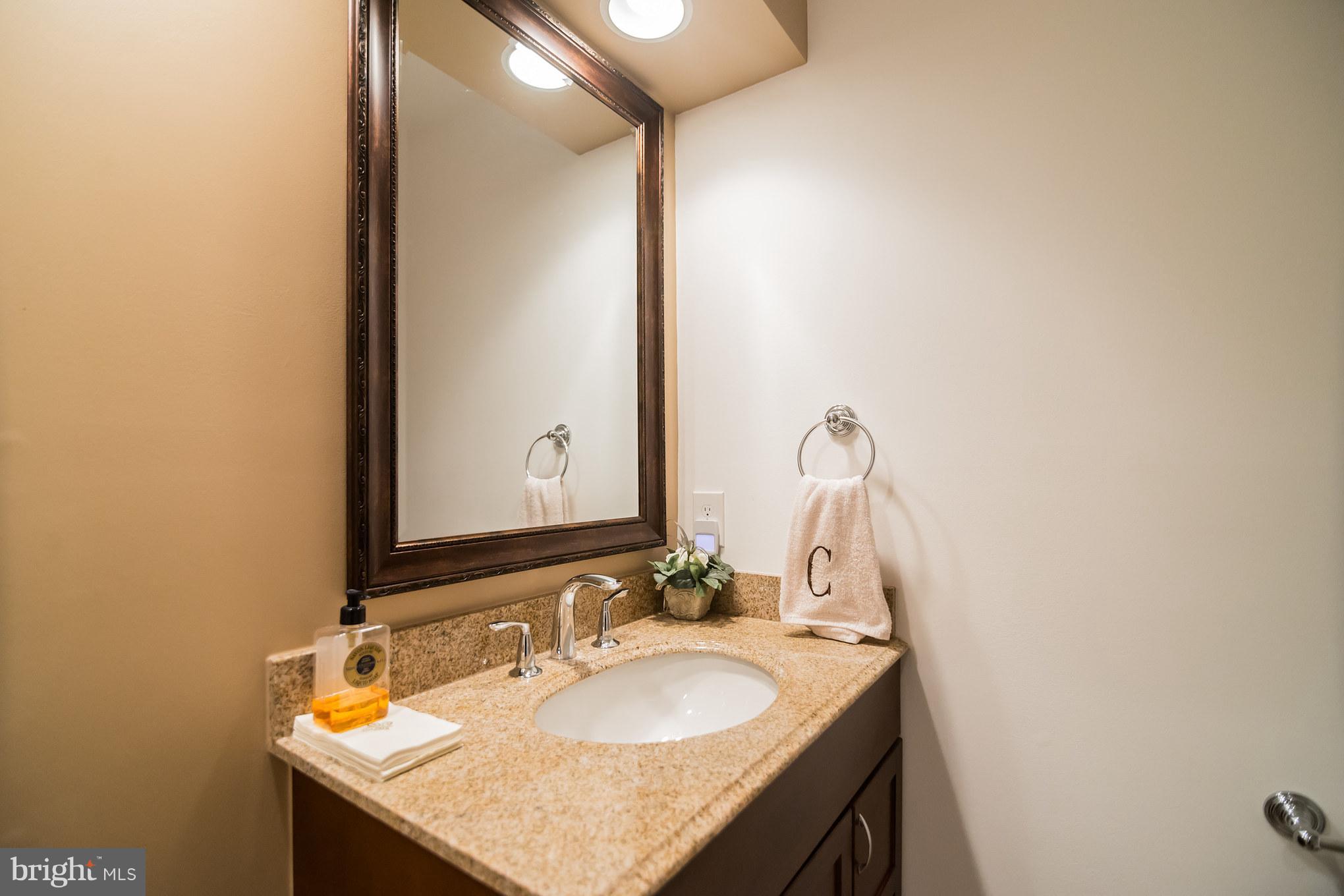 13016 Smoketown Road Woodbridge, VA 22192 - Photo 20 of 30 a bathroom with a granite countertop sink and a mirror