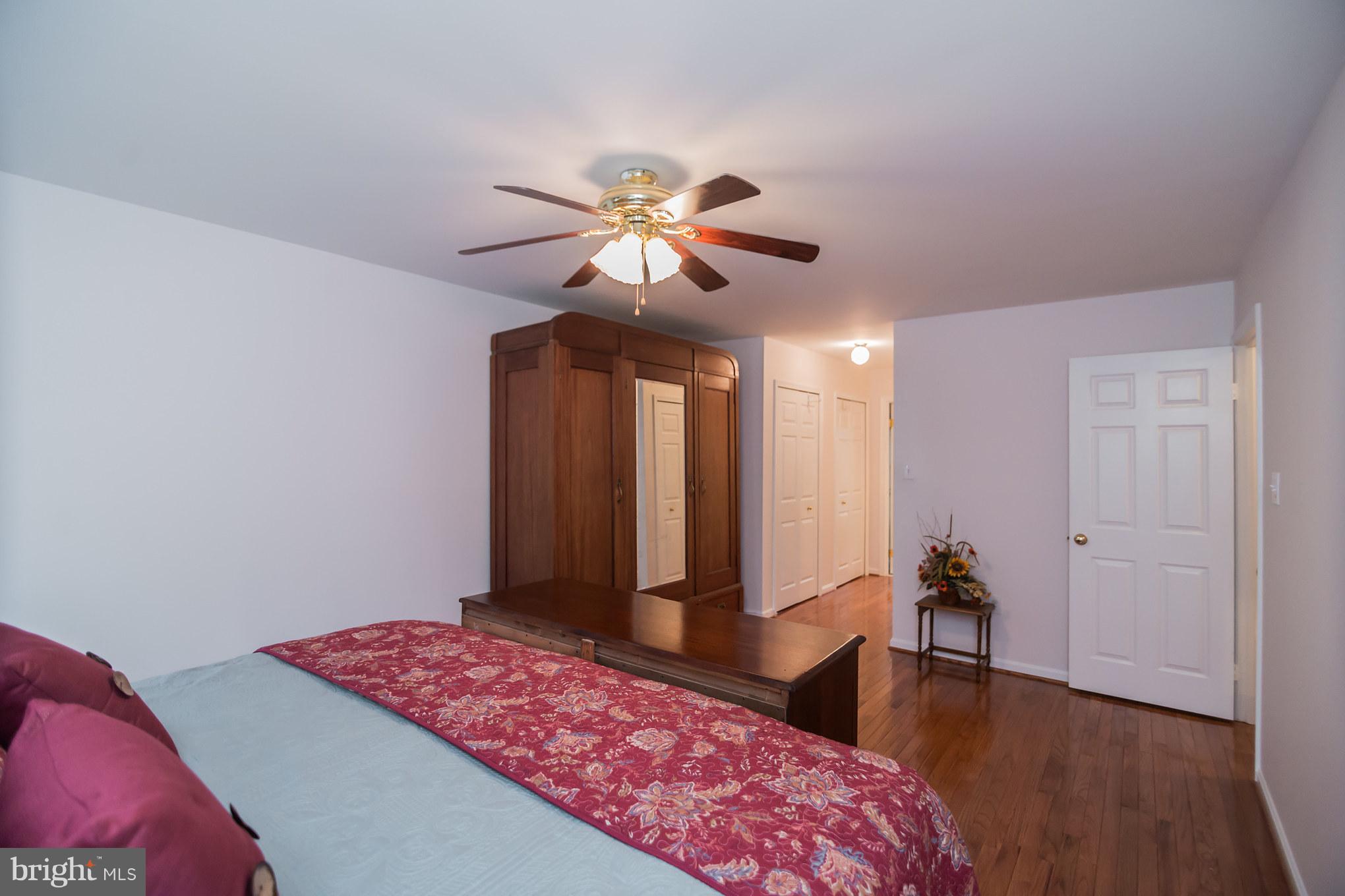 13016 Smoketown Road Woodbridge, VA 22192 - Photo 22 of 30 a bedroom with a bed and a chandelier