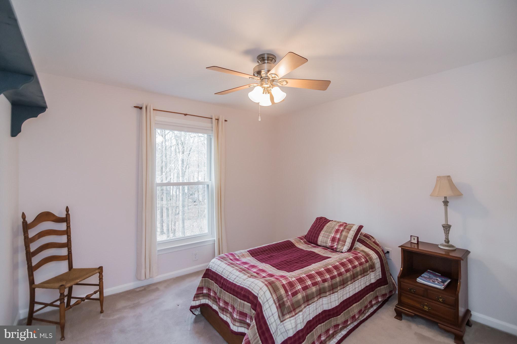 13016 Smoketown Road Woodbridge, VA 22192 - Photo 25 of 30 a bedroom with a bed and a chandelier