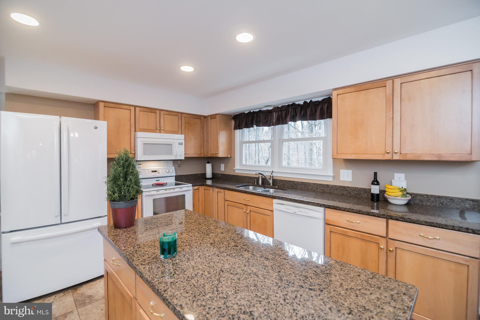 13016 Smoketown Road Woodbridge, VA 22192 - Photo 7 of 30 a kitchen with a sink a counter top space cabinets and stainless steel appliances