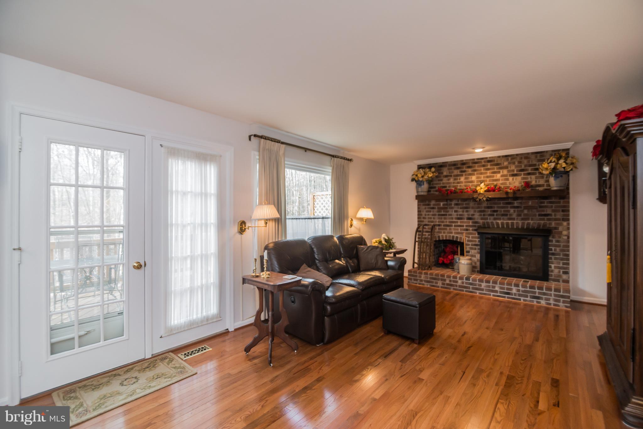 13016 Smoketown Road Woodbridge, VA 22192 - Photo 10 of 30 a living room with furniture and a fireplace