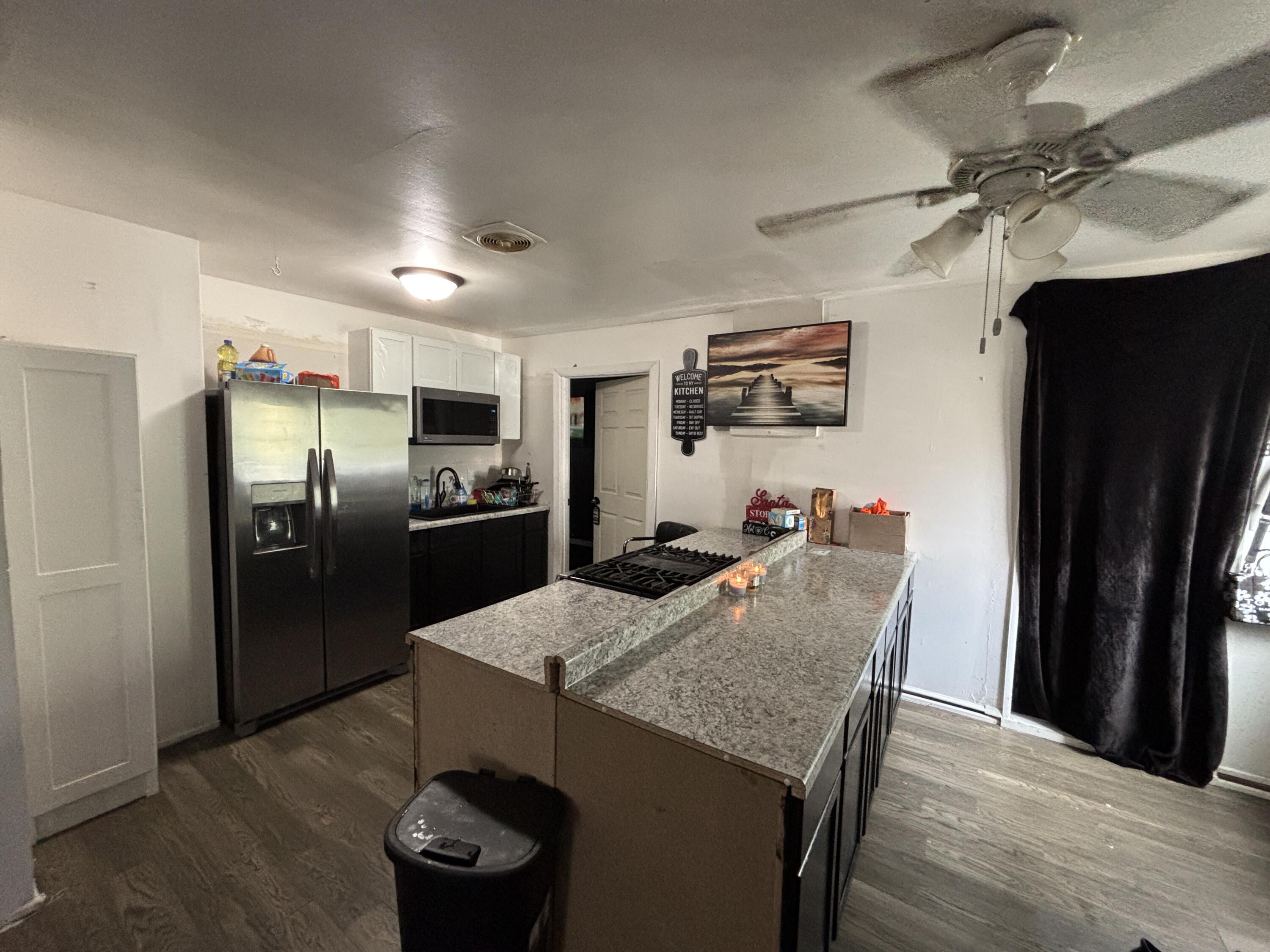 2154 Whitcomb Street Gary, IN 46404 - Photo 3 of 12 a kitchen with stainless steel appliances granite countertop a refrigerator a stove a sink and a refrigerator