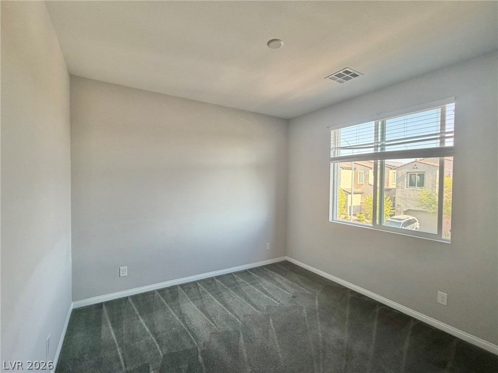 9953 Tucket Point Court Las Vegas, NV 89178 - Photo 20 of 22 Comfortable carpeting and ample natural light fill this inviting bedroom space.