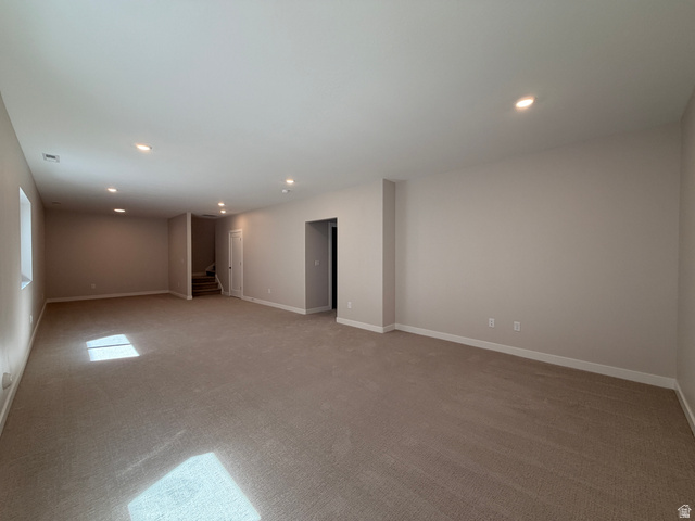 539 East Rimrock Lane Heber City, UT 84032 - Photo 10 of 13 Expansive carpeted room featuring recessed lighting, neutral wall tones, white baseboards, and a window