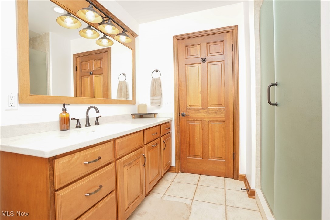 7780 Knauf Road Canfield, OH 44406 - Photo 18 of 48 Bathroom featuring a stall shower, tile patterned flooring, and vanity