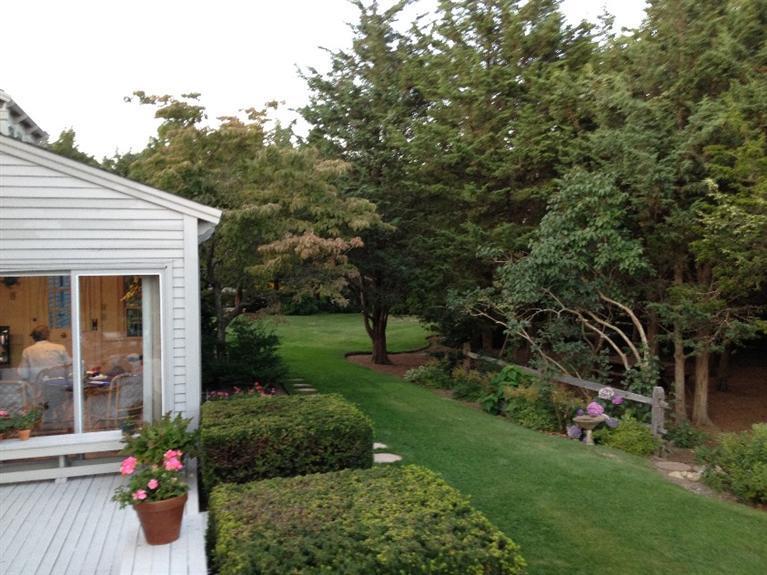 148 Point Hill Road West Barnstable, MA 02668 - Photo 32 of 35 a view of a backyard with potted plants and large trees