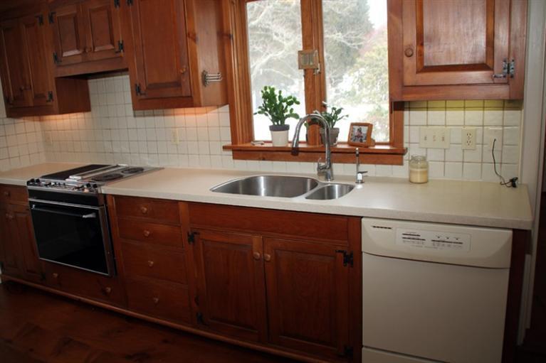 148 Point Hill Road West Barnstable, MA 02668 - Photo 9 of 35 a kitchen with a sink stove and cabinets