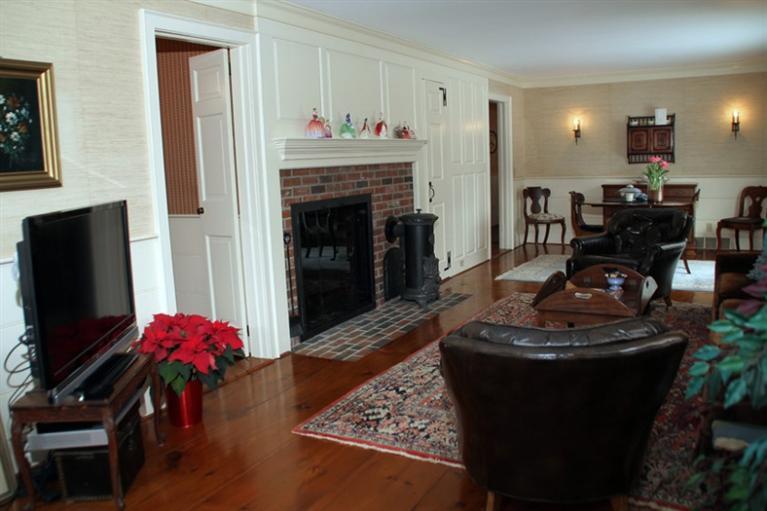 148 Point Hill Road West Barnstable, MA 02668 - Photo 10 of 35 a living room with furniture a fireplace and a flat screen tv