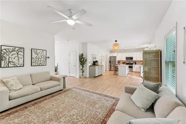 a living room with furniture and kitchen view