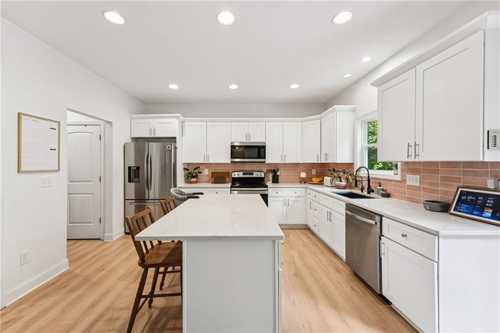 621 Stonehurst Lane Canton, GA 30114 - Photo 15 of 62 a kitchen with refrigerator a sink and white cabinets