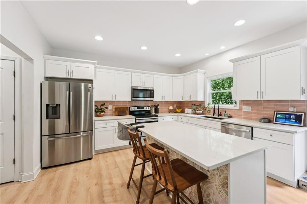 621 Stonehurst Lane Canton, GA 30114 - Photo 16 of 62 a kitchen with a refrigerator a stove top oven a sink and cabinets