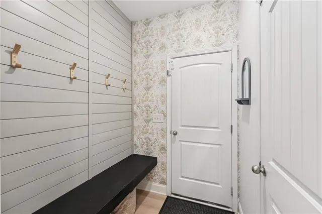 a bedroom with a bed and a large mirror