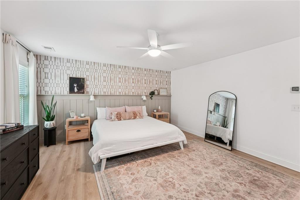 621 Stonehurst Lane Canton, GA 30114 - Photo 27 of 62 a bedroom with a bed and a large mirror