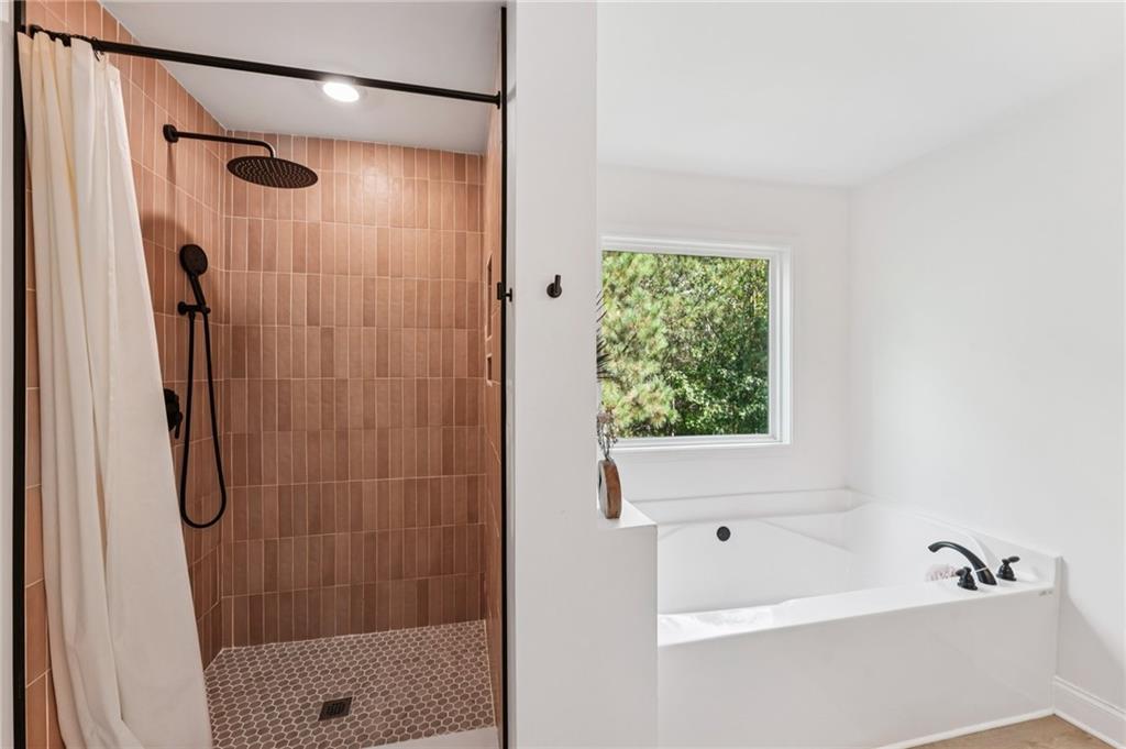 621 Stonehurst Lane Canton, GA 30114 - Photo 30 of 62 a bathroom with a shower and a bath tub