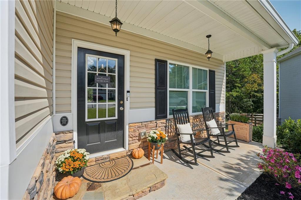 621 Stonehurst Lane Canton, GA 30114 - Photo 3 of 62 a view of a porch with chairs and potted plants