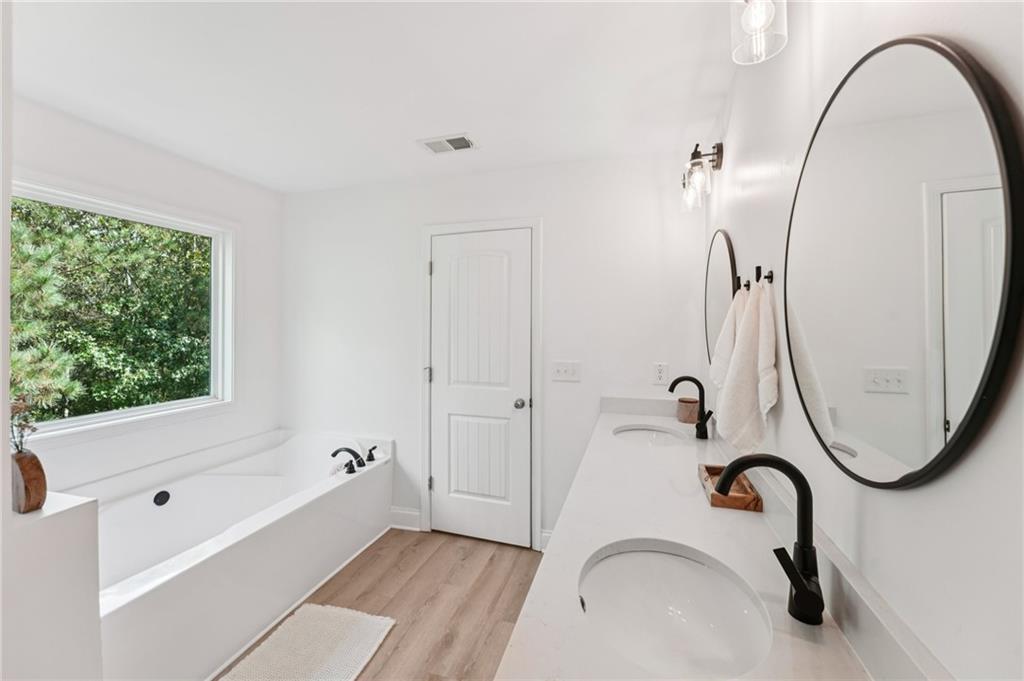 621 Stonehurst Lane Canton, GA 30114 - Photo 32 of 62 a bathroom with a tub sink and mirror