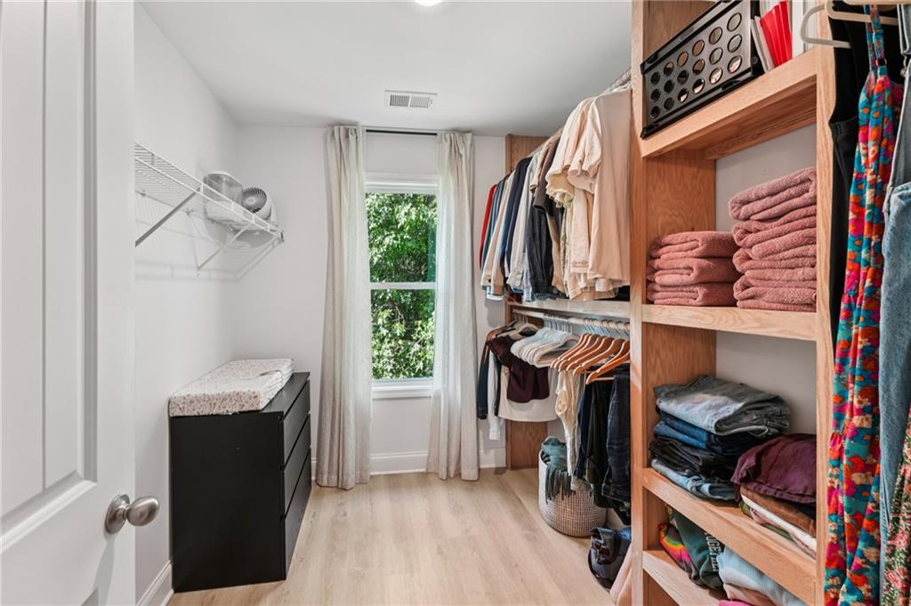 621 Stonehurst Lane Canton, GA 30114 - Photo 33 of 62 a view of walk in closet with clothes and shoes