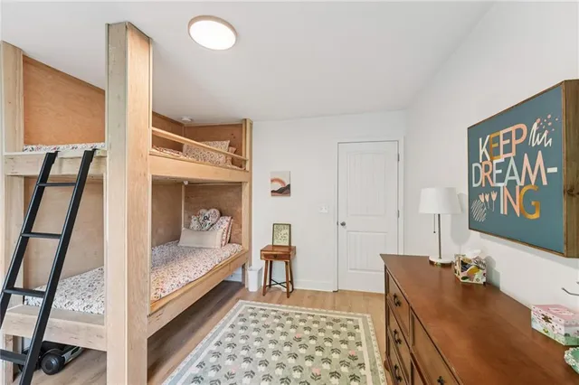 a spacious bedroom with a bed and a large window